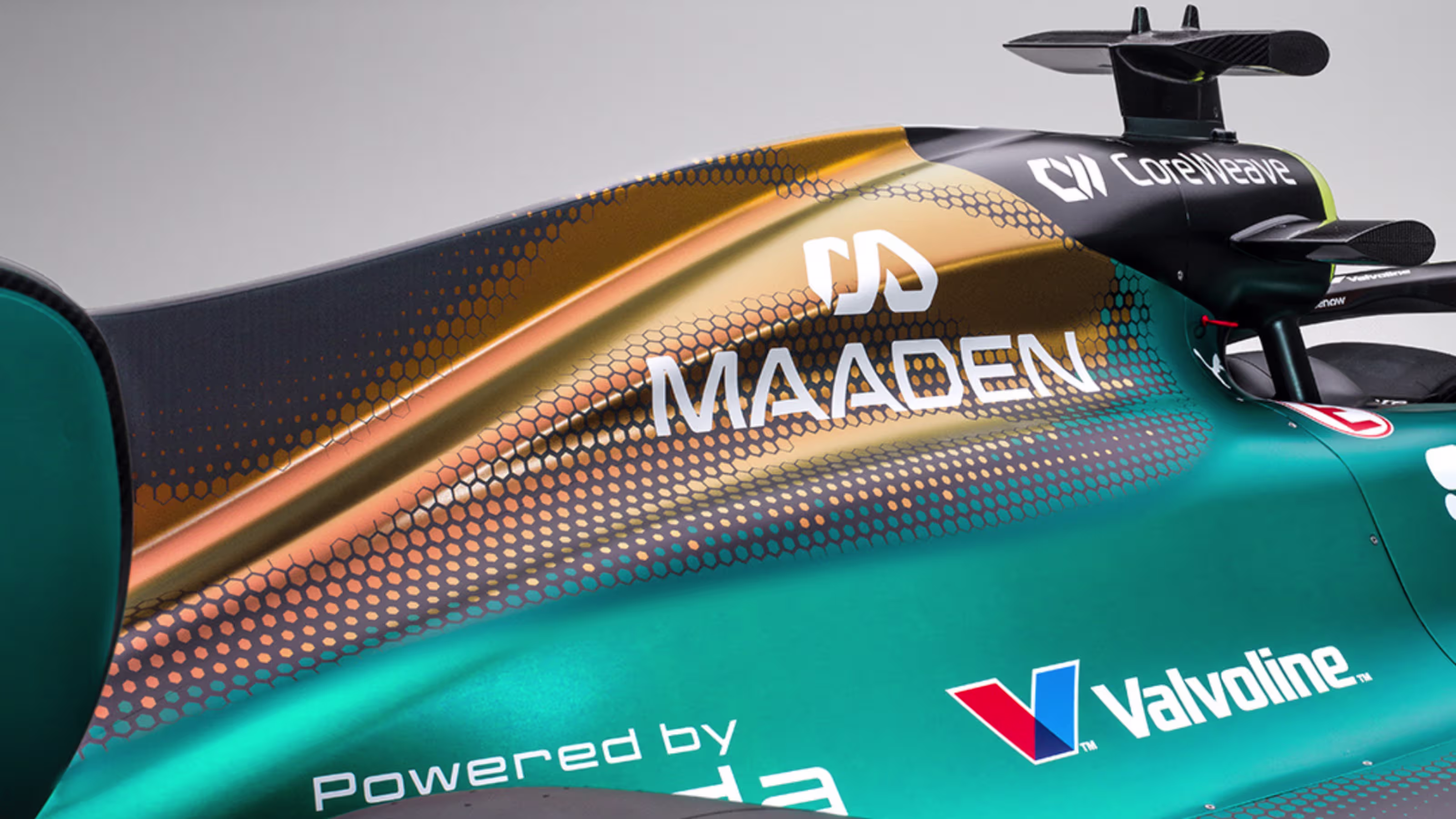 Aston Martin AMR25 F1 Monaco Grand Prix 2026 Maaden iridescent livery additional 16x9 promotional studio angle showing the iridescent paint scheme and the layered green-to-gold hexagonal gradient detail